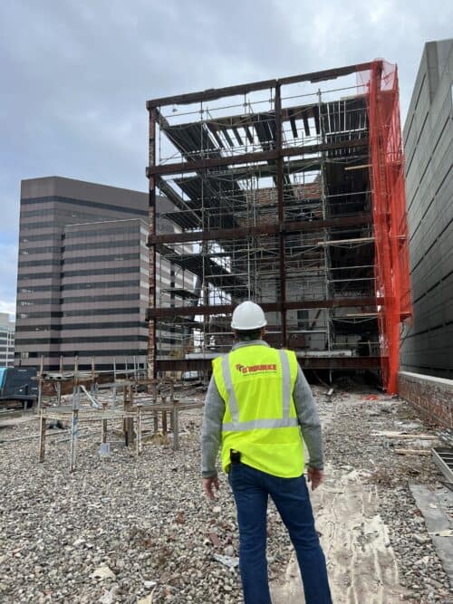 O'Rourke's demolition expert observes a building demolition project in action